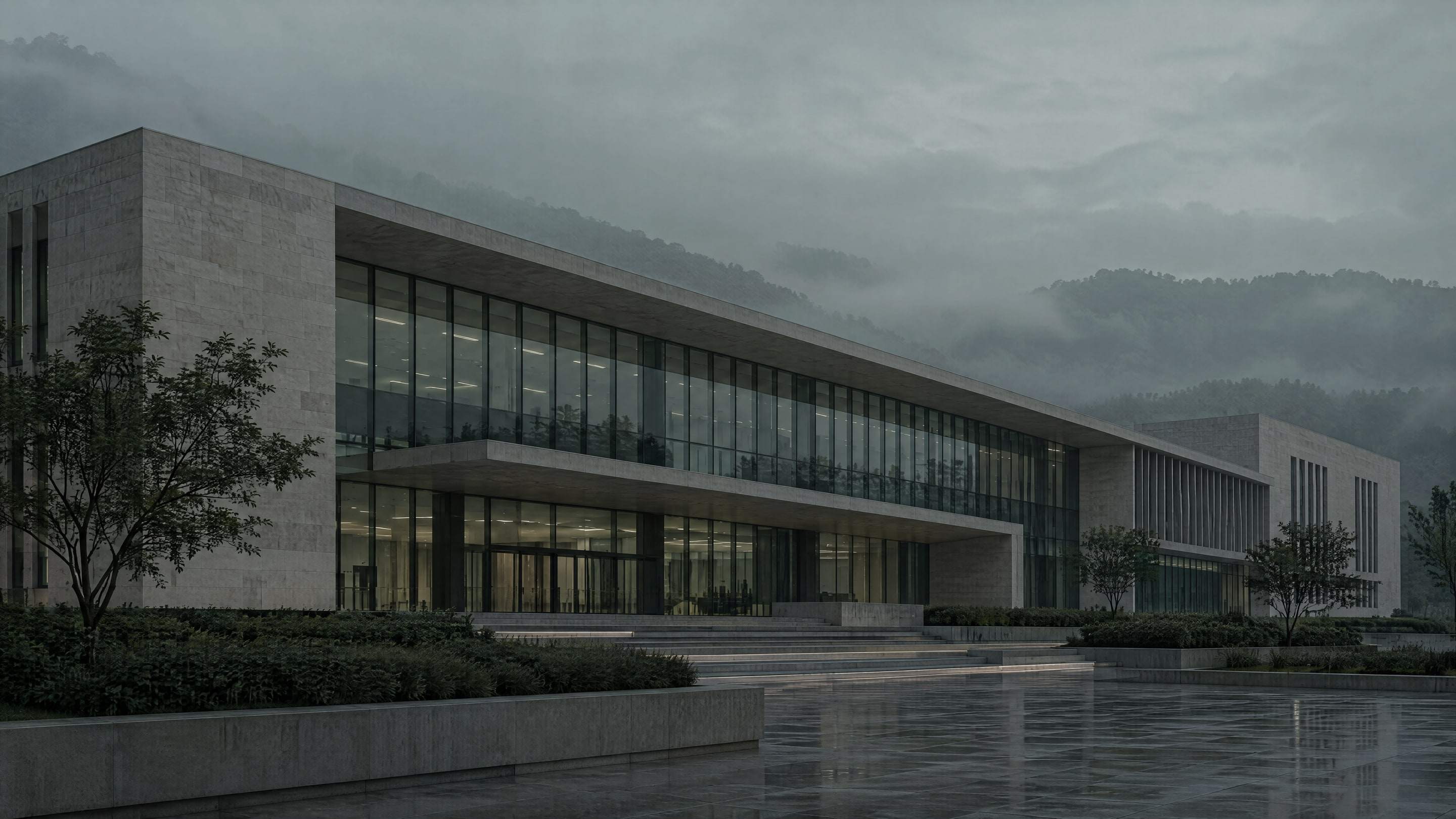 Edificio cívico contemporáneo de piedra y vidrio entre la niebla